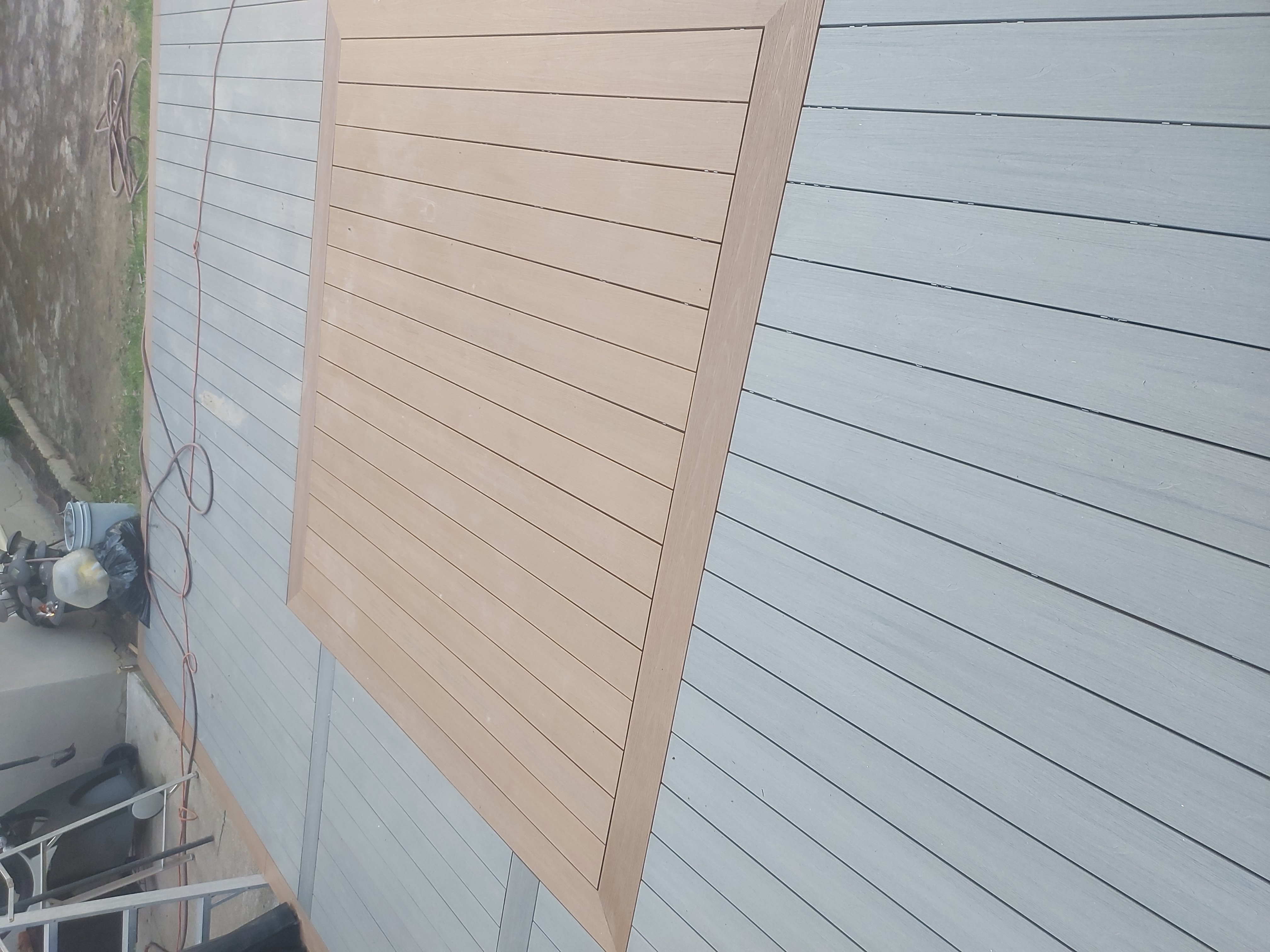 Finished composite deck with clean lines and a covered seating area in a Niagara backyard
