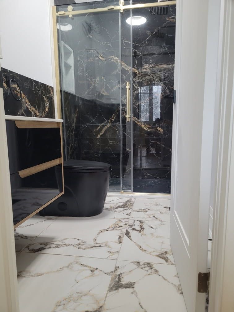 Renovated bathroom with bright modern finishes, a tiled shower, and updated fixtures