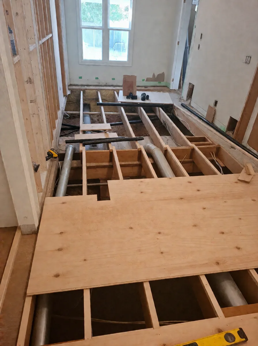 Bedroom floor rebuild with new joists, ductwork and the first plywood subfloor sheets