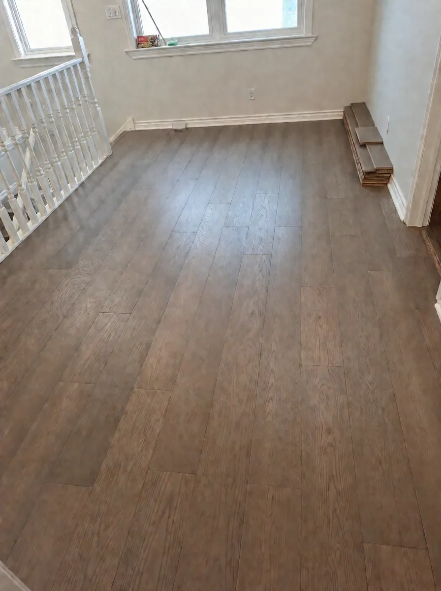 Upstairs landing with new grey-brown oak flooring, white railing and a triple window