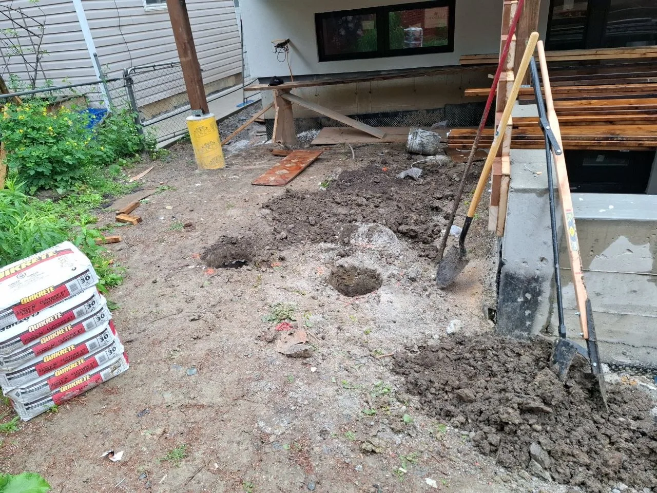 Modern Toronto townhome deck build with natural wood decking and railing — footing excavation
