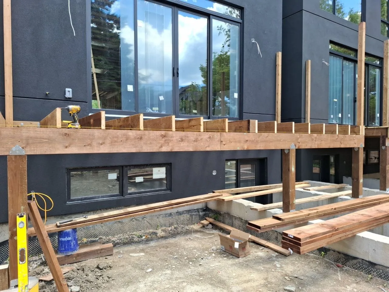 Modern Toronto townhome deck build with natural wood decking and railing — frame with railing posts