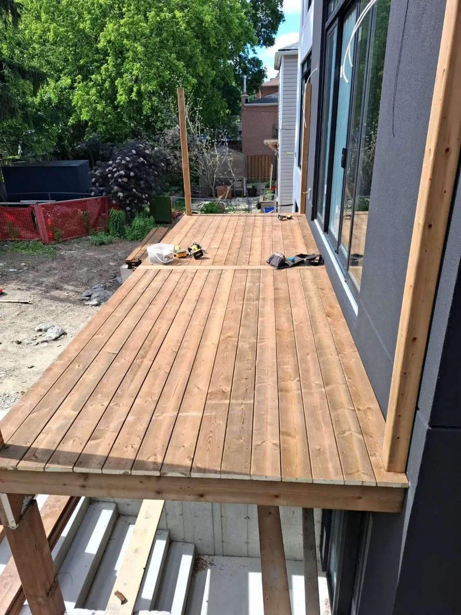 Modern Toronto townhome deck build with natural wood decking and railing — finished decking rear view