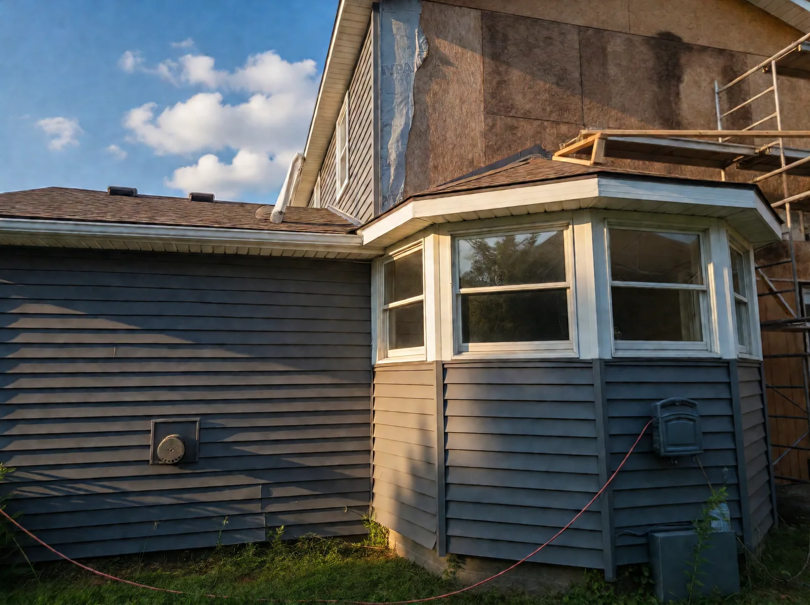 Fort Erie home before the siding renovation, with old grey horizontal siding on the bay window and rear wall