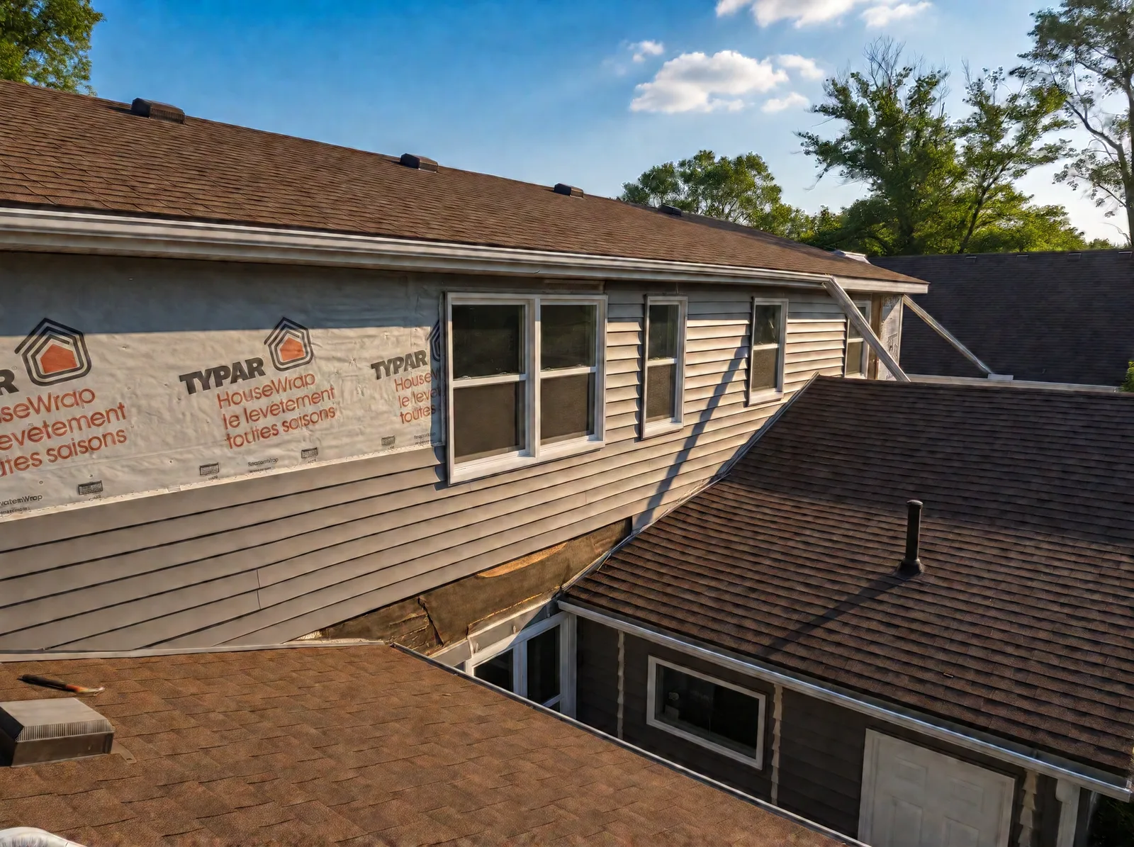 View from the roof of the upper wall covered in Typar HouseWrap, with old horizontal siding still below